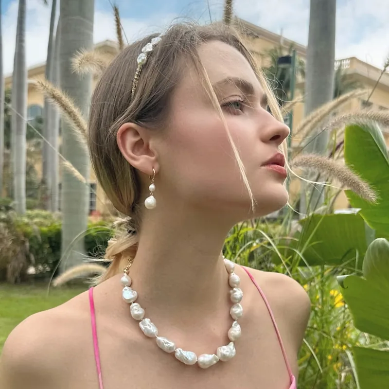 Model wearing baroque freshwater pearl necklace and drop earrings