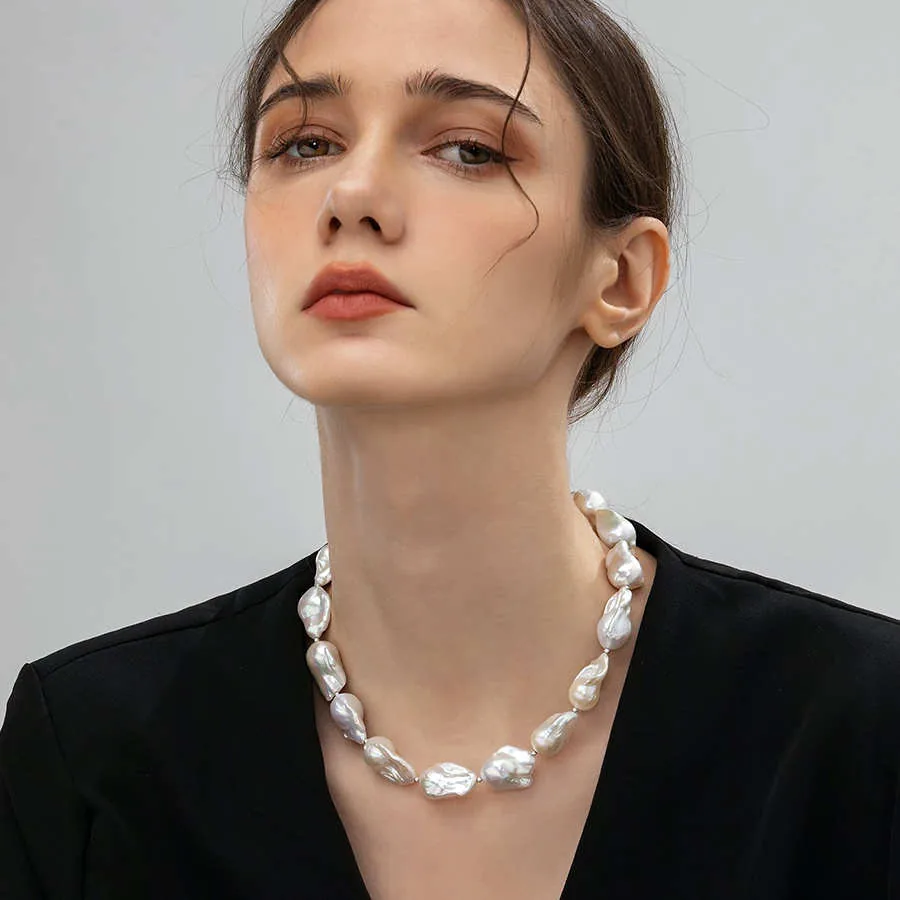 Model wearing a baroque freshwater pearl necklace with a black outfit