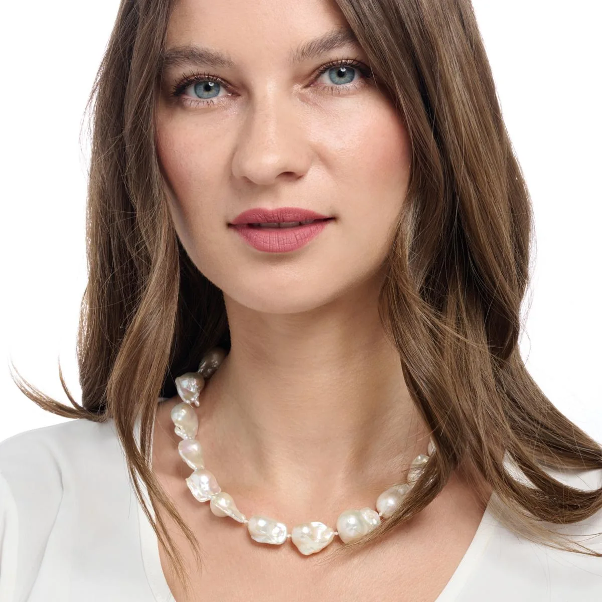 Baroque freshwater pearl necklace shown on a model against a white background